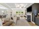 Comfortable living room featuring a fireplace, coffered ceilings, and natural light streaming through the windows at 1017 Saltwater Cir, Johns Island, SC 29455