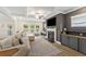 Bright living space with a fireplace and backyard views, seamlessly flowing to the kitchen and dining areas at 1017 Saltwater Cir, Johns Island, SC 29455