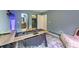 Spacious home office featuring a large desk and doorway to a closet and modern bathroom at 1017 Saltwater Cir, Johns Island, SC 29455