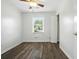 Bedroom featuring white walls, gray wood floors, ceiling fan, and a window with natural light at 102 Berkshire Ct, Goose Creek, SC 29445