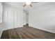 Bedroom featuring white walls, gray wood floors, ceiling fan, and closet with double doors at 102 Berkshire Ct, Goose Creek, SC 29445