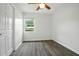 Bedroom featuring gray wood floors, white walls, ceiling fan, and a window with natural light at 102 Berkshire Ct, Goose Creek, SC 29445