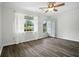 Bright bedroom features new floors, a ceiling fan, a window, and a door to the backyard at 102 Berkshire Ct, Goose Creek, SC 29445