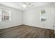 Bedroom featuring white walls, gray wood floors, ceiling fan, and dual windows with blinds at 102 Berkshire Ct, Goose Creek, SC 29445