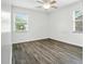 Bedroom featuring white walls, gray wood floors, and a window with natural light at 102 Berkshire Ct, Goose Creek, SC 29445