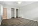 Bedroom featuring gray wood floors, white walls, closet with double doors, and a bathroom at 102 Berkshire Ct, Goose Creek, SC 29445