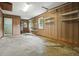 Interior view of garage with wood paneling, shelving, and concrete floors at 102 Berkshire Ct, Goose Creek, SC 29445