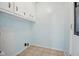 Simple laundry room with tile floors and cabinetry for easy organization at 102 Berkshire Ct, Goose Creek, SC 29445