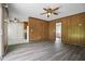 Living room boasts wood paneling, new floors, and a ceiling fan, seamlessly flowing to other rooms at 102 Berkshire Ct, Goose Creek, SC 29445