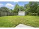 Backyard shed with green grass and a wood privacy fence at 102 Berkshire Ct, Goose Creek, SC 29445