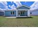 Beautiful home backyard featuring a covered patio and blue siding at 122 Royal Cainhoy Way, Huger, SC 29450