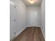 Inviting hallway featuring wood-look flooring and fresh, neutral paint throughout at 122 Royal Cainhoy Way, Huger, SC 29450