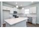 Modern kitchen with white cabinets, stainless steel appliances, and a large island at 122 Royal Cainhoy Way, Huger, SC 29450