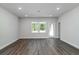 Bright living space with wood-look flooring and views of the backyard at 122 Royal Cainhoy Way, Huger, SC 29450