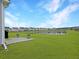 Expansive backyard with lush green grass, a cozy patio, and scenic views of the pond, perfect for outdoor relaxation and entertainment at 123 Oyama Rd, Summerville, SC 29486