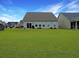 Spacious backyard with a well-maintained lawn and a clear view of the house's rear exterior, showcasing outdoor living potential at 123 Oyama Rd, Summerville, SC 29486