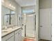 Bathroom with granite counters, double sinks, and a tiled shower with glass door at 123 Oyama Rd, Summerville, SC 29486