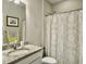 Bathroom features a granite countertop vanity, decorative shower curtain, and fresh white toilet at 123 Oyama Rd, Summerville, SC 29486