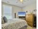 Serene bedroom with natural light, neutral decor, and a large TV at 123 Oyama Rd, Summerville, SC 29486