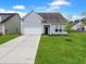 Beautiful single-Gathering home with an attached garage, lush green lawn, and well-maintained landscaping, offering comfort and style at 123 Oyama Rd, Summerville, SC 29486
