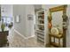 Bright hallway with wood floors, decorative shelving, and view into the living room at 123 Oyama Rd, Summerville, SC 29486