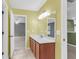 Bright bathroom with a wooden vanity and mirror, leading into an open-concept bedroom at 127 Rawlins Dr, Summerville, SC 29485