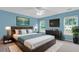 A bright bedroom with a ceiling fan, lake view art and lots of natural light at 127 Rawlins Dr, Summerville, SC 29485
