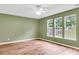 Cozy bedroom features light-colored wood floors, three windows, and neutral wall paint to brighten up the space at 127 Rawlins Dr, Summerville, SC 29485