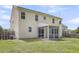 Back exterior view of a two-story home featuring a screened-in patio and lush green lawn at 127 Rawlins Dr, Summerville, SC 29485