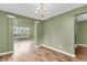 Open foyer featuring beautiful hardwood floors, an elegant chandelier, and seamless transition to other living spaces at 127 Rawlins Dr, Summerville, SC 29485