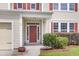 Inviting front entrance with a red door, manicured bushes, and classic architectural details at 127 Rawlins Dr, Summerville, SC 29485