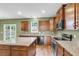 Modern kitchen features an island, granite countertops, stainless steel appliances, and a sliding door to the backyard at 127 Rawlins Dr, Summerville, SC 29485