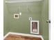 Functional laundry area with hookups, storage, and modern wood-look flooring at 127 Rawlins Dr, Summerville, SC 29485