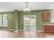 Spacious living room with light-colored wood flooring, a sliding glass door to the backyard, and a bar with cabinets at 127 Rawlins Dr, Summerville, SC 29485