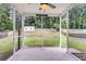 Screened-in patio with ceiling fan, perfect for enjoying the outdoors bug-free, facing spacious yard at 127 Rawlins Dr, Summerville, SC 29485