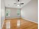 An empty bedroom featuring vaulted ceilings, a ceiling fan, hardwood floors, and natural light from multiple windows at 1321 Wild Olive Dr, Mount Pleasant, SC 29464