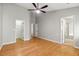 A bedroom featuring hardwood floors, with access to a walk-in closet and an ensuite bathroom through separate doorways at 1321 Wild Olive Dr, Mount Pleasant, SC 29464