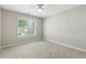 Neutral bedroom with a ceiling fan, a window looking out to the yard, and neutral carpet at 1321 Wild Olive Dr, Mount Pleasant, SC 29464
