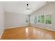 An empty bedroom featuring vaulted ceilings and hardwood floors, illuminated by natural light from multiple windows at 1321 Wild Olive Dr, Mount Pleasant, SC 29464