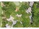 Aerial view of 1326 Sea Elder Ct. surrounded by lush greenery, near a golf course, in a serene community at 1326 Sea Elder Dr, Kiawah Island, SC 29455