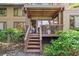 Home with a cozy wooden back porch and a stairway at 1326 Sea Elder Dr, Kiawah Island, SC 29455