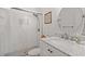 Bathroom featuring white tile shower, and vanity with marble countertop and oval mirror at 1326 Sea Elder Dr, Kiawah Island, SC 29455