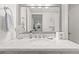 Bright bathroom featuring a modern vanity with a marble countertop, ample lighting, and stylish accessories at 1326 Sea Elder Dr, Kiawah Island, SC 29455
