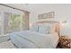 Bright bedroom with a ceiling fan, hardwood floors, a window and a comfortable bed with decorative pillows at 1326 Sea Elder Dr, Kiawah Island, SC 29455