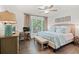 Bright bedroom with a ceiling fan, hardwood floors, a window and a comfortable bed with decorative pillows at 1326 Sea Elder Dr, Kiawah Island, SC 29455