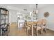 Inviting dining area with a wooden table, open to the modern kitchen with white cabinets and stainless steel appliances at 1326 Sea Elder Dr, Kiawah Island, SC 29455
