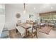 Charming dining area featuring a rustic wood table, shiplap walls, and natural light from large windows at 1326 Sea Elder Dr, Kiawah Island, SC 29455
