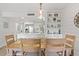 Stylish dining area with a wooden table and chairs, open to a modern kitchen with white countertops and cabinets at 1326 Sea Elder Dr, Kiawah Island, SC 29455