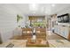 Bright dining area showcasing a rustic wood table, comfortable seating, and scenic views of the golf course at 1326 Sea Elder Dr, Kiawah Island, SC 29455