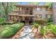 Inviting two-story condo with a charming wooden walkway surrounded by lush greenery and a pathway leading to the entrance at 1326 Sea Elder Dr, Kiawah Island, SC 29455